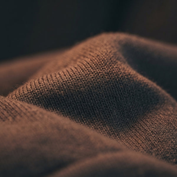 Close-up of premium cotton-blend fleece fabric on a dog hoodie showing high-quality, structured texture.